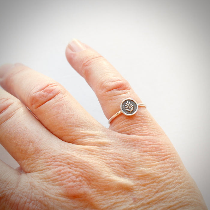 The back to the garden stacking ring is styled on a hand for size reference