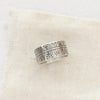The nordic stamped band ring styled on tan linen
