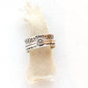 The flower spinner ring styled on tan linen
