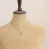 A mannequin wearing the mini talara shield necklace