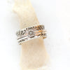 The flower spinner ring styled on tan linen