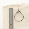 A african jasper halo hoop earring next to a ruler for size reference