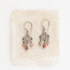 The mini talara andesine earrings styled on tan linen