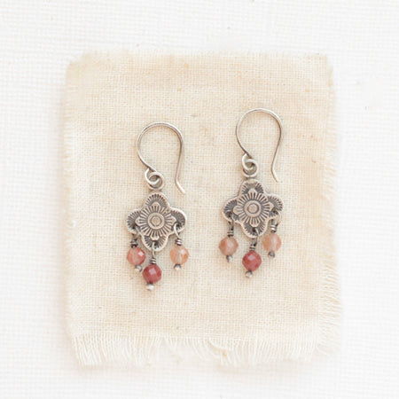 The mini talara andesine earrings styled on tan linen
