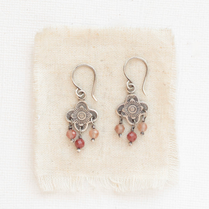 The mini talara andesine earrings styled on tan linen