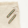 The apatite beaded bronze bar earrings styled on tan linen