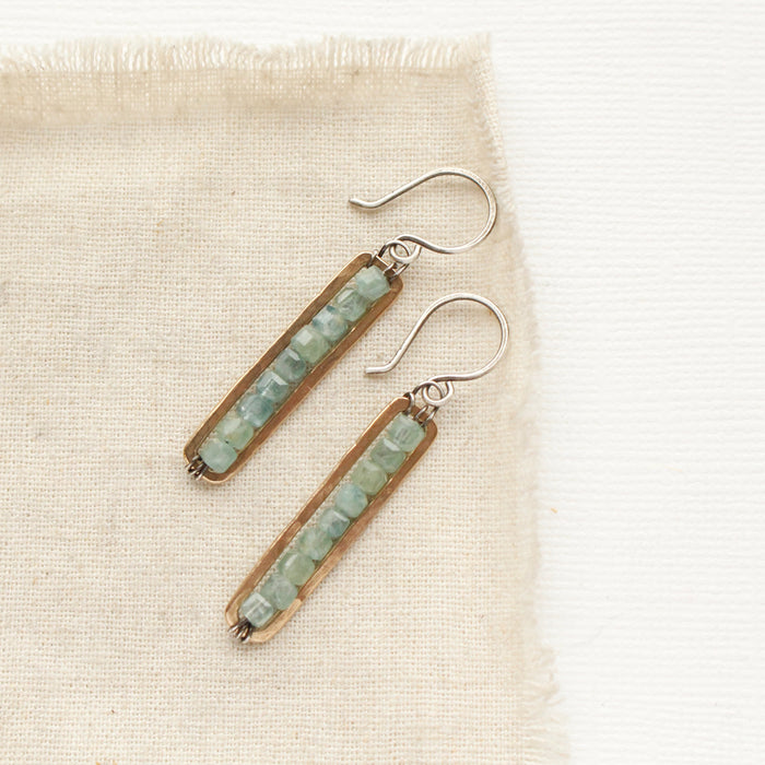 The apatite beaded bronze bar earrings styled on tan linen