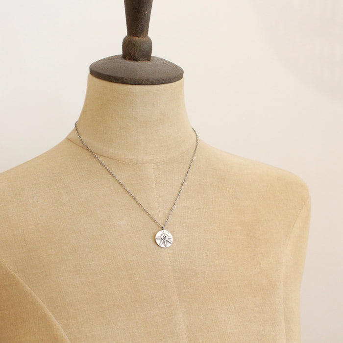 A mannequin wearing the big musana necklace
