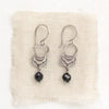 The black tourmaline jolie earrings styled on tan linen