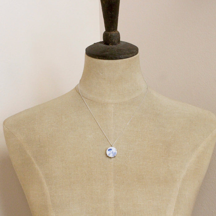 A mannequin wearing the blue bloom vintage plate necklace