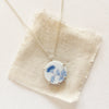 The blue bloom vintage plate necklace styled on tan linen