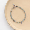 The zircon and labradorite roma bracelet styled on tan linen