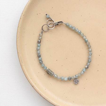 The zircon and labradorite roma bracelet styled on tan linen