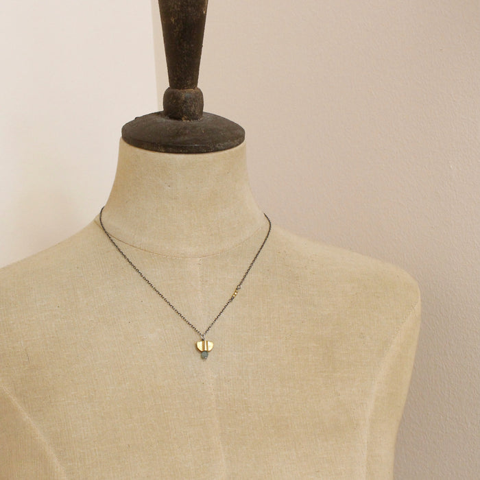 A mannequin wearing the brass and kyanite mythos necklace