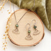 The bronze asmi triangle and african jasper earrings styled on wood with the matching necklace
