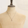 A mannequin wearing the bronze wanderer hoop necklace