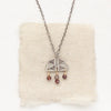 The brown zircon mixed metal pakal arch necklace styled on tan linen