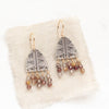 The brown zircon pakal fringe earrings styled on tan linen