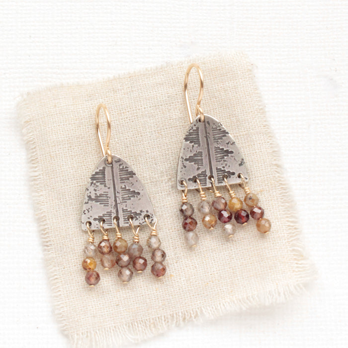 The brown zircon pakal fringe earrings styled on tan linen