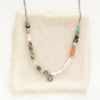 The talara sun mesa necklace styled on tan linen