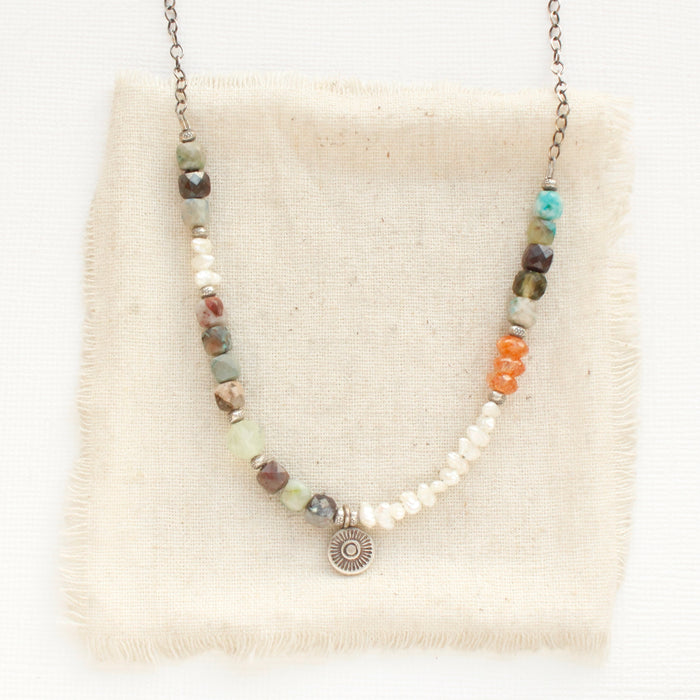 The talara sun mesa necklace styled on tan linen