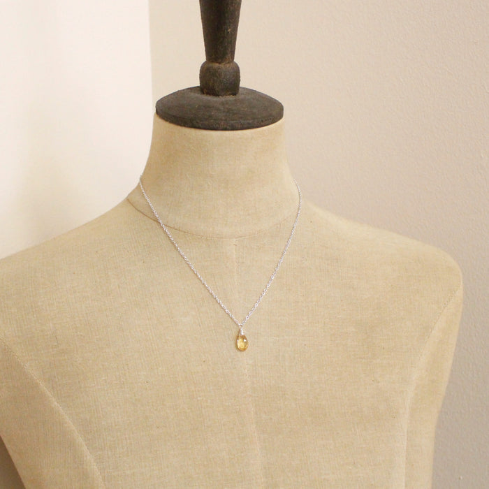 A mannequin wearing the citrine drop silver necklace