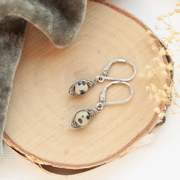 The perfect wrap dalmatian jasper earrings styled on wood with gray velvet and dried grass