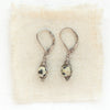 The perfect wrap dalmtian jasper earrings styled on tan linen