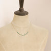 A mannequin wearing the emerald collar necklace