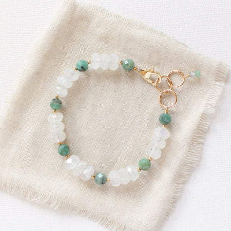 The emerald and moonstone bracelet styled on tan linen