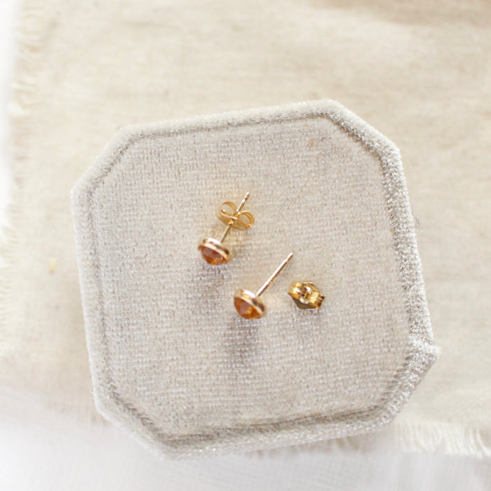 The citrine post earrings styled on a velvet box to show the post and butterfly ear back