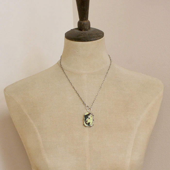 A mannequin wearing the fish tales vintage plate necklace