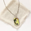 The fish tales vintage plate necklace styled on tan linen
