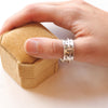 A hand wearing the galaxy spinner ring 