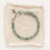 The apatite cube bracelet styled on tan linen