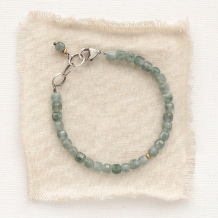 The apatite cube bracelet styled on tan linen
