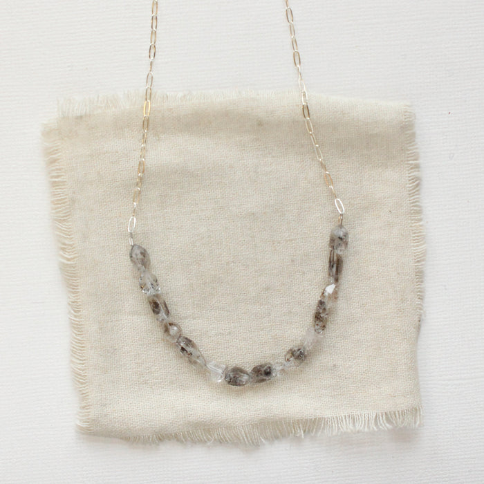 The herkimer diamond collar necklace styled on tan linen