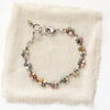 The kaleidoscope bracelet styled on tan linen
