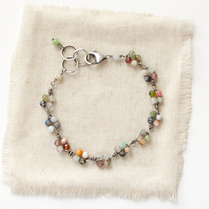 The kaleidoscope bracelet styled on tan linen