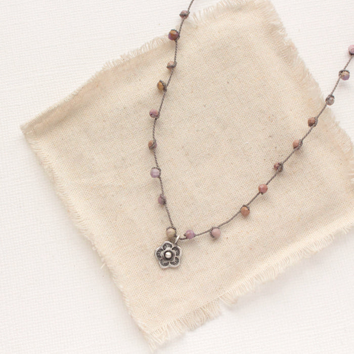 The knotted phosphosiderite mini cactus flower necklace styled on tan linen