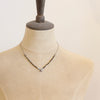 A mannequin wearing the knotted serenity soar necklace