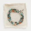 The knotted sunset bracelet styled on tan linen
