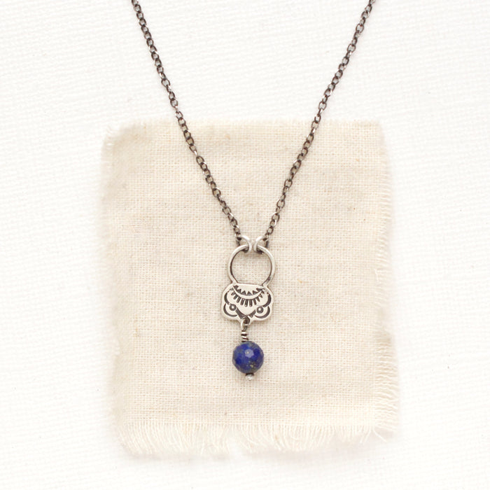 The lapis jolie necklace styled on tan linen