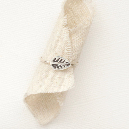 The leaf stacking ring styled on a piece of rolled linen