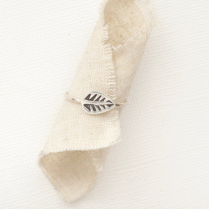 The leaf stacking ring styled on a piece of rolled linen