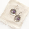 The lepidolite jolie cupped earrings styled on tan linen