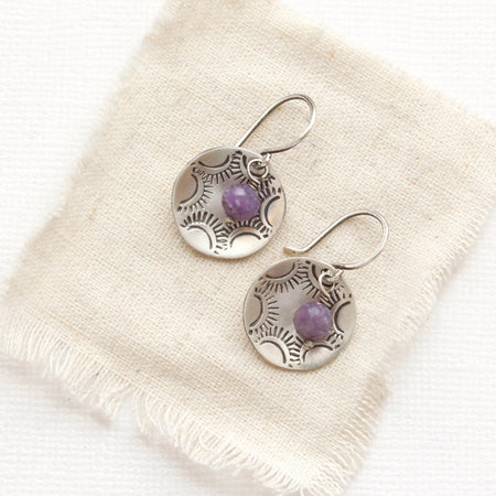 The lepidolite jolie cupped earrings styled on tan linen