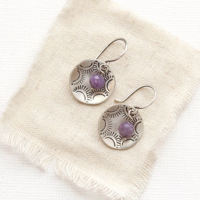 The lepidolite jolie cupped earrings styled on tan linen