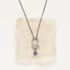 The lepidolite jolie necklace styled on tan linen