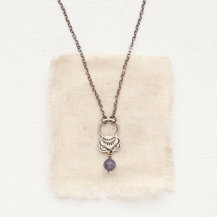 The lepidolite jolie necklace styled on tan linen